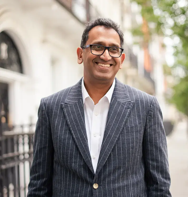 Professor Prasanna Sooriakumaran standing outdoors on a London street